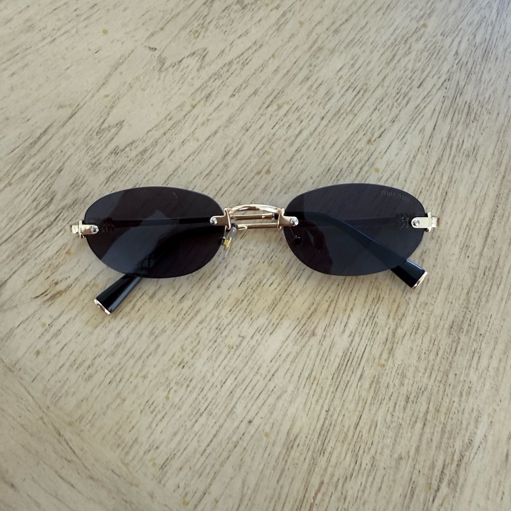 Rimless Oval Sunglasses with Gold Accents